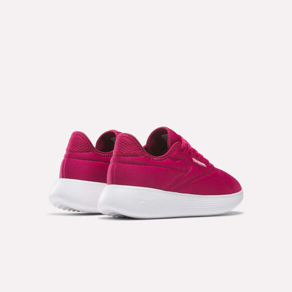 A pair of Women's Active Lite Shoes by Reebok in bright pink with white soles, featuring DMX technology, shown from the back and side against a plain light background.