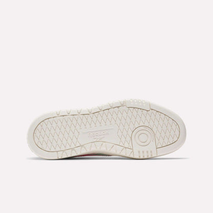 The image shows the sole of a white Reebok Campio XT Double Shoe for big kids, featuring a textured zigzag tread pattern and an embossed Reebok logo—ideal for fans of classic retro sneakers.