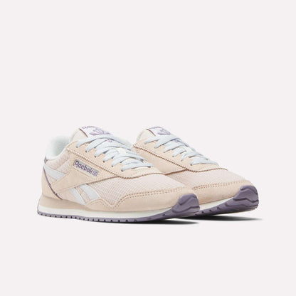 The Women's Classic AZ Shoes by Reebok are beige with white accents, a light purple outsole, and classic branding on the side and tongue, shown against a white background.