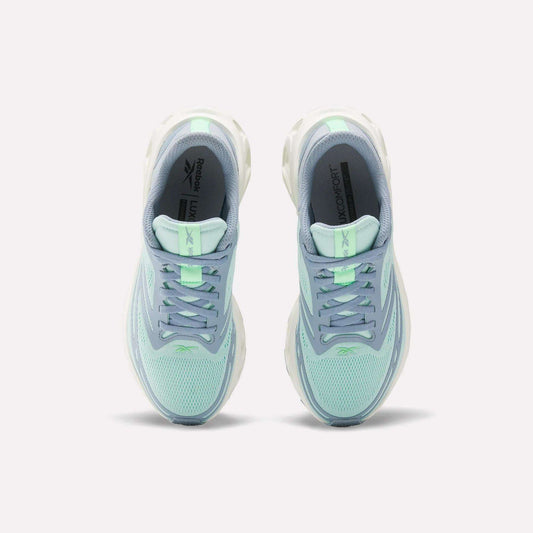 A pair of Women's Fuel Flex Run Shoes by Reebok in light blue and mint green are shown side by side from above, highlighting the laces, mesh uppers, branded insoles, and Fuel Flex midsole for lasting comfort.