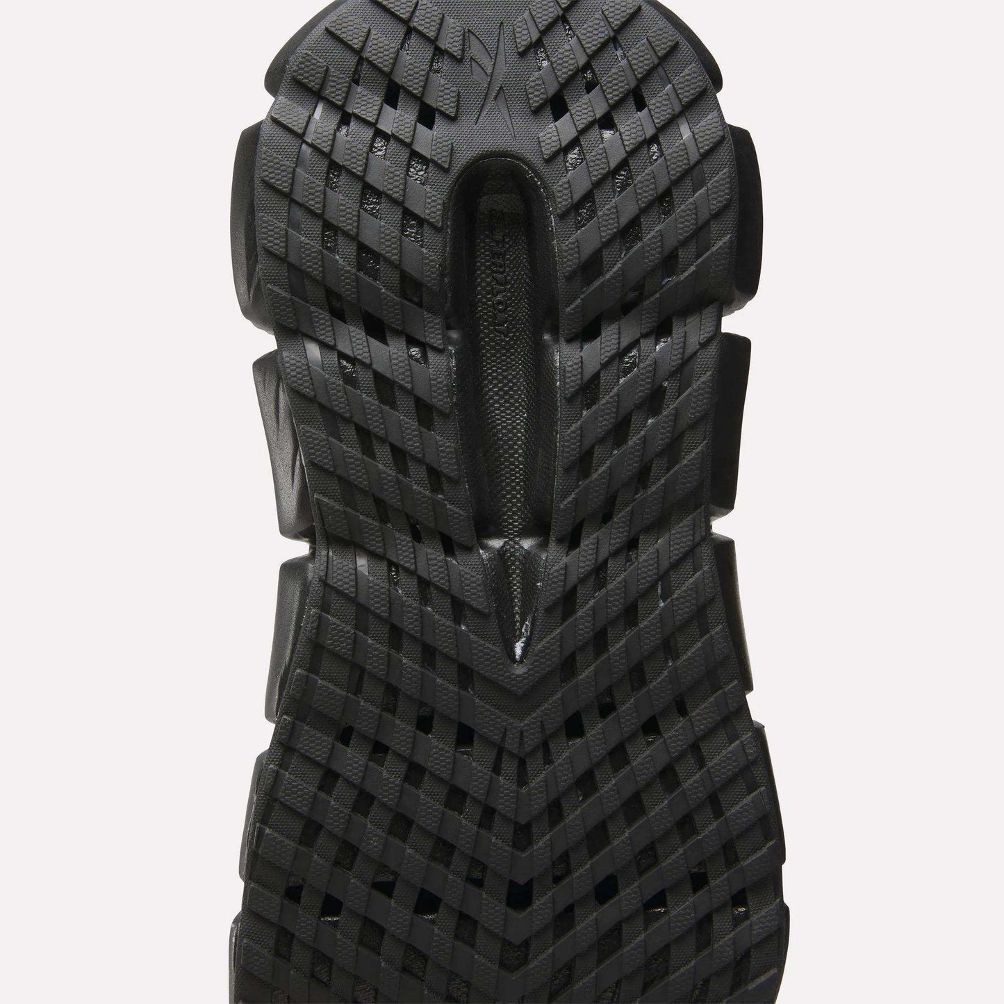 Close-up of a black sole on Reebok Women's FloatZig 2 Running Shoes, showcasing a textured grid pattern with raised sections for traction and energy-returning Superfloat+ cushioning inspired by high-performance running footwear.