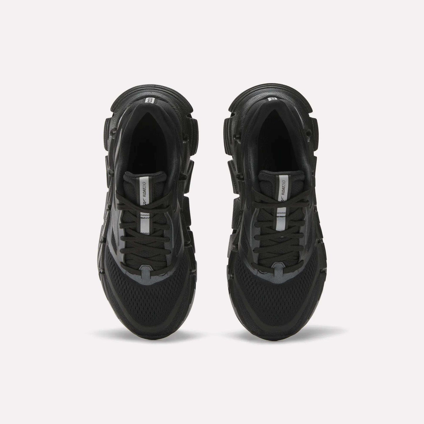 A pair of Reebok Women's FloatZig 2 black running shoes with thick soles, black laces, mesh detailing, and Superfloat+ cushioning, viewed from above on a plain white background.