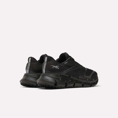 A pair of Reebok Men's FloatZig 2 Running Shoes in black with thick, energy-returning cushioning soles and bold logos, positioned side by side at an angle on a plain white background.
