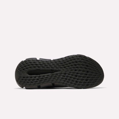 The image shows the bottom view of a black Reebok Men's FloatZig 2 Running Shoe outsole with a grid-like textured tread for grip and energy-returning cushioning, all set against a plain white background.