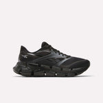 The Reebok Men's FloatZig 2 Running Shoes feature a black mesh upper, segmented sole, and energy-returning cushioning, shown in a sleek side view on a plain white background.