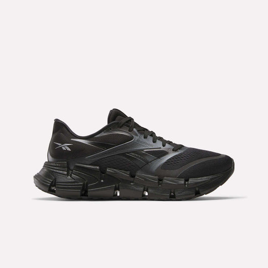 The Reebok Men's FloatZig 2 Running Shoes feature a black mesh upper, segmented sole, and energy-returning cushioning, shown in a sleek side view on a plain white background.