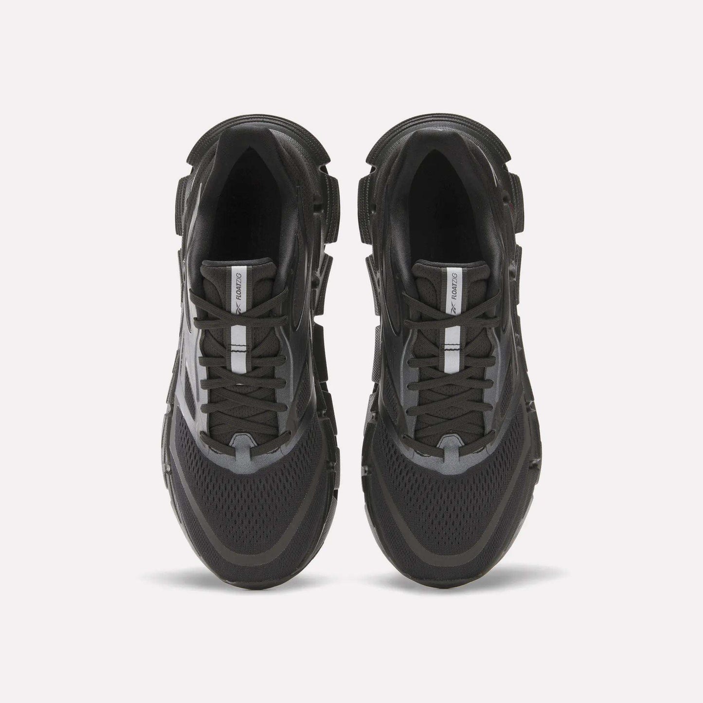 The Reebok Men's FloatZig 2 Running Shoes in black and gray are shown from above on a white background, featuring mesh panels, energy-returning cushioned soles, lace-up design, and a central logo tag on the tongue.