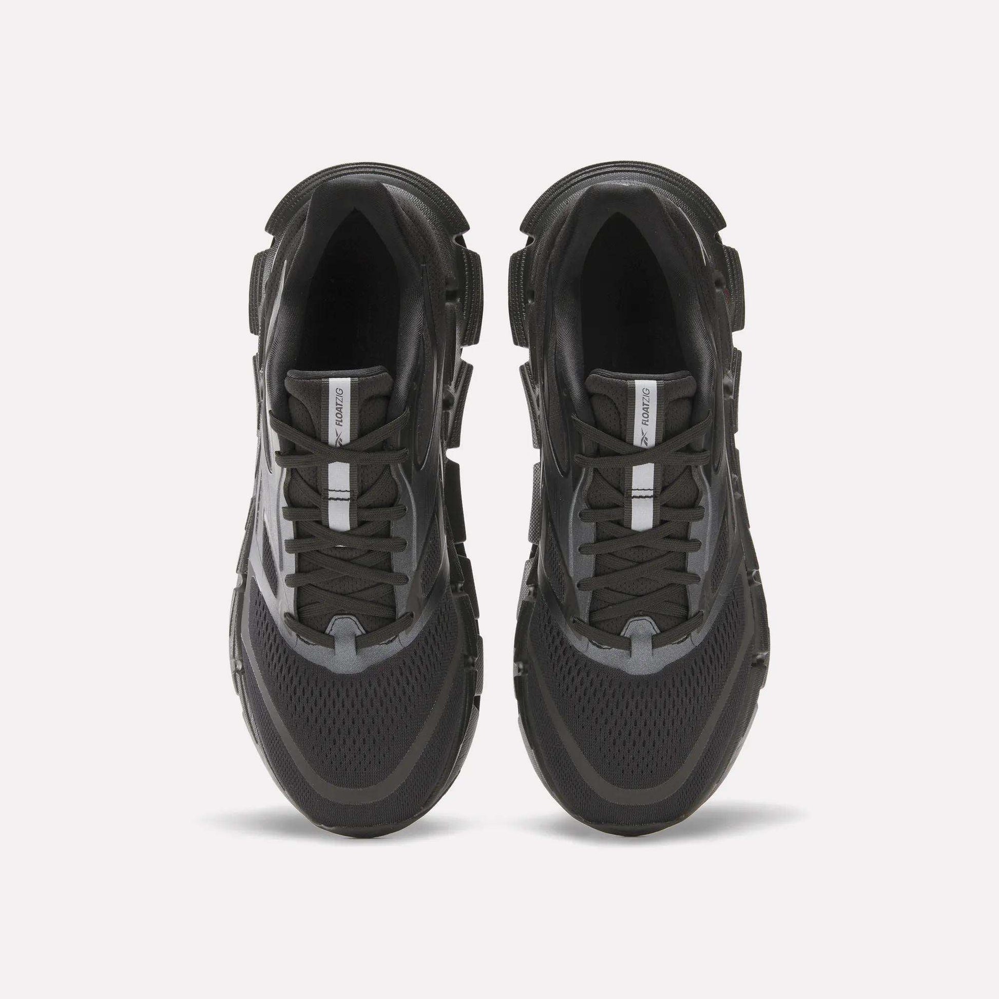 The Reebok Men's FloatZig 2 Running Shoes in black and gray are shown from above on a white background, featuring mesh panels, energy-returning cushioned soles, lace-up design, and a central logo tag on the tongue.
