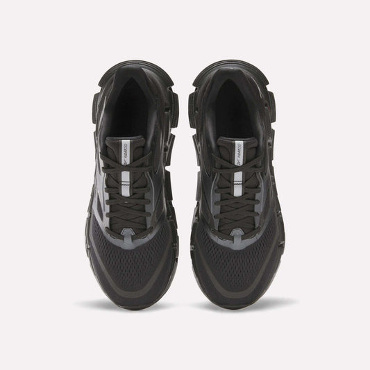 The Reebok Men's FloatZig 2 Running Shoes in black and gray are shown from above on a white background, featuring mesh panels, energy-returning cushioned soles, lace-up design, and a central logo tag on the tongue.
