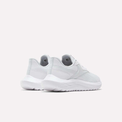The Reebok Women's Energen Lux Running Shoes are shown in white from the back and side on a plain light background, highlighting their versatile style, thick textured soles, and comfort.