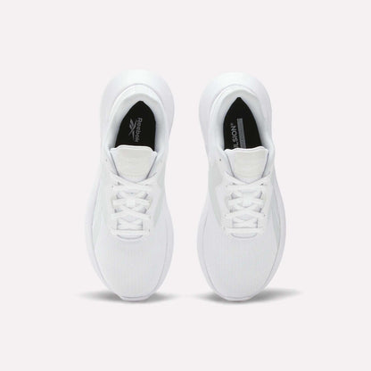 A pair of Reebok Women's Energen Lux Running Shoes viewed from above displays laces, mesh toe texture, and black Reebok logos on the inner soles. These lightweight shoes are side by side on a plain light background.