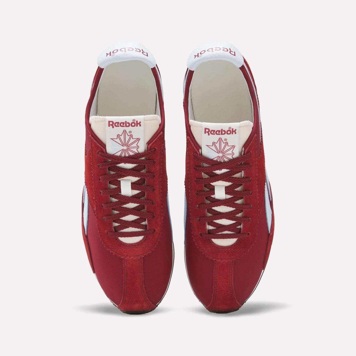 A pair of Reebok R400 Shoes in red with white accents and laces, seen from above. The sneakers display the Reebok logo and a red maple leaf emblem on the tongue.