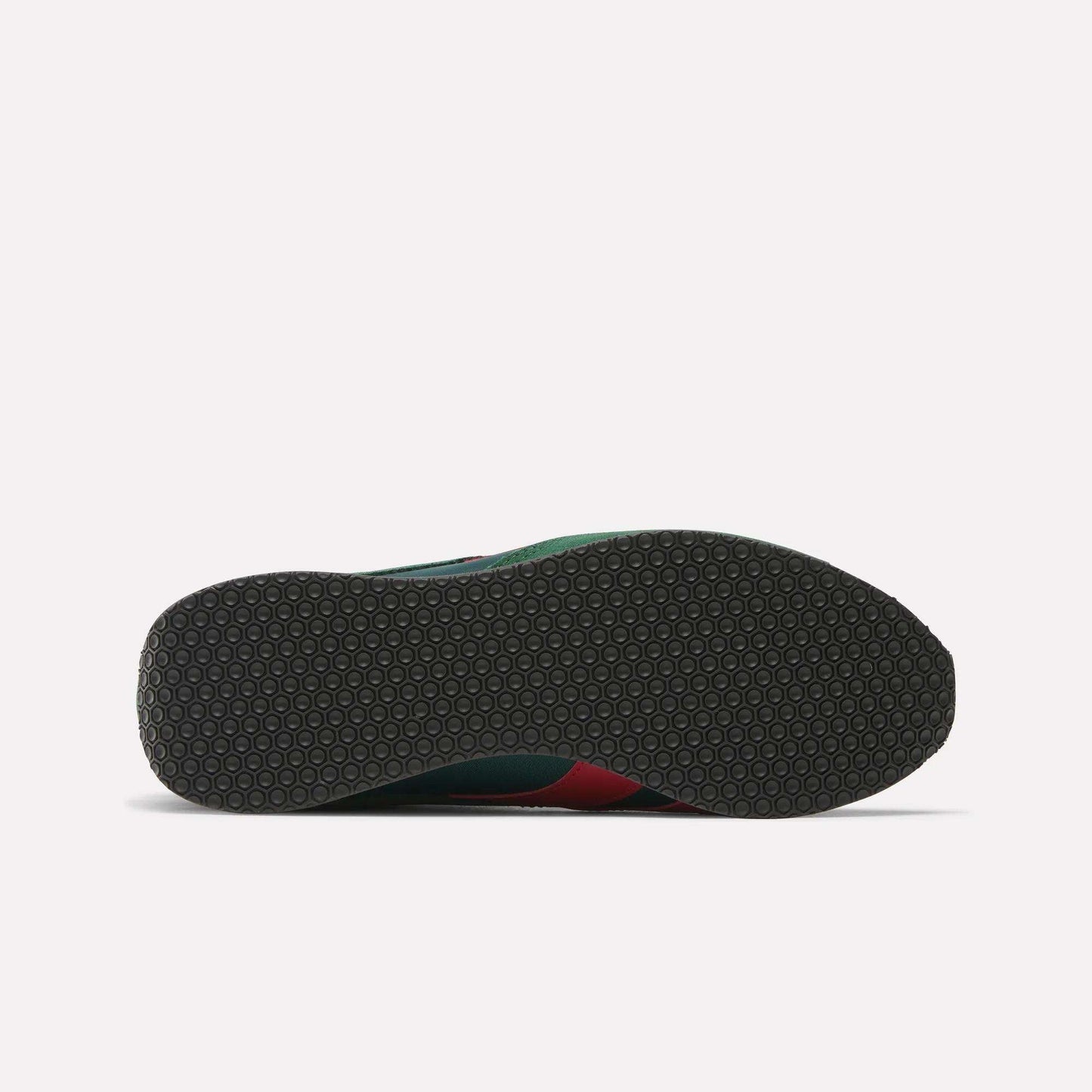 The image displays the sole of Reebok R400 Shoes, featuring a dark, flat outsole with a textured hexagonal pattern. Small hints of green and red from the upper are visible at the edge, reflecting classic retro sneaker style.