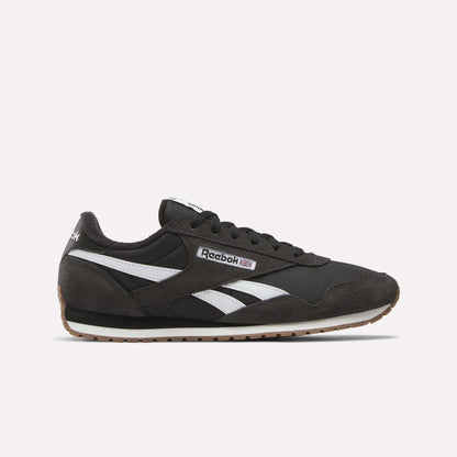 The Reebok Classic AZ Shoes in black feature white and gray accents, white side stripes, and a brown rubber sole that channels true '70s style, shown against a plain light background.