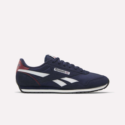 The Reebok Classic AZ Shoes in navy blue feature white accents, a white sole, and red heel details for vintage 70s style. The iconic Reebok logo appears on the side and tongue, all set against a plain white background.