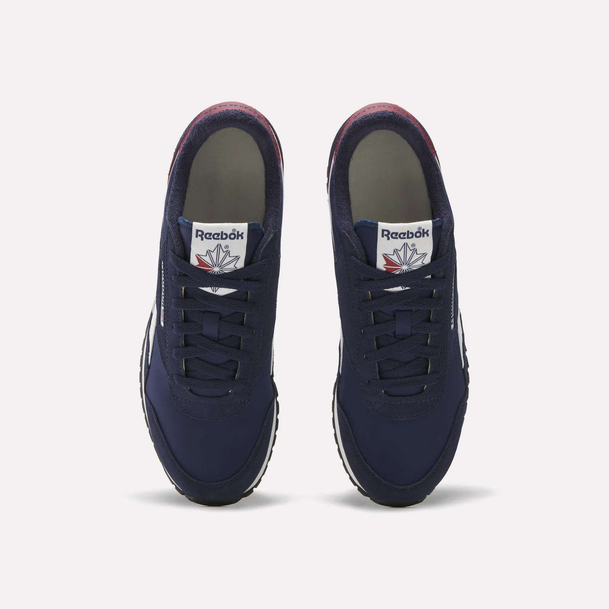 A pair of Reebok Classic AZ Shoes in navy blue, shown from above with laces, white tongue tags bearing the Reebok logo, and white rubber soles on a plain background—evoking classic retro running style.