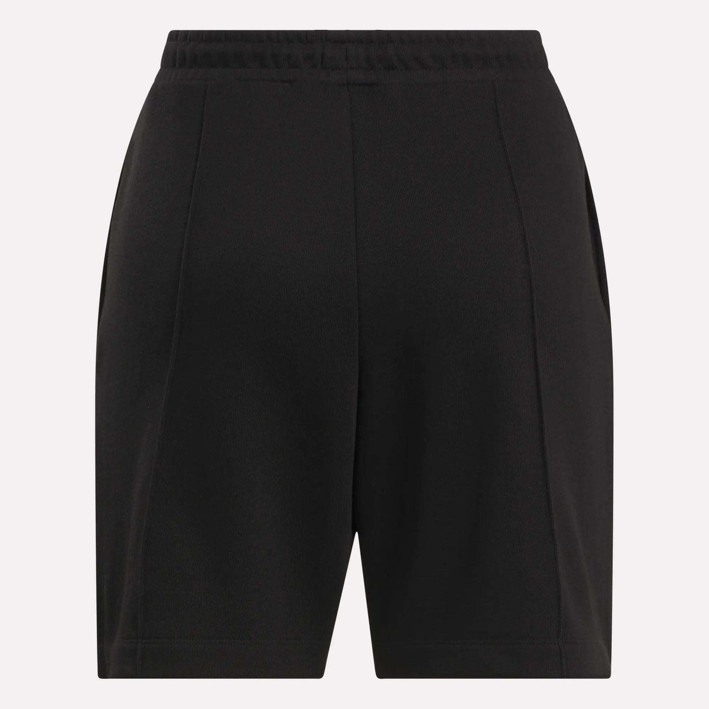 Reebok Women's Pintuck Long Shorts in black, featuring an elastic waistband, front pleats, and side pockets, made from a soft cotton-blend fleece. Displayed against a plain light background.