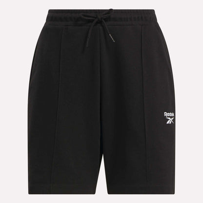 The Reebok Women's Pintuck Long Shorts are black cotton-blend fleece shorts featuring an elastic waistband, drawstring, and a white logo on the left leg. Their simple, casual design is ideal for sports or leisure.
