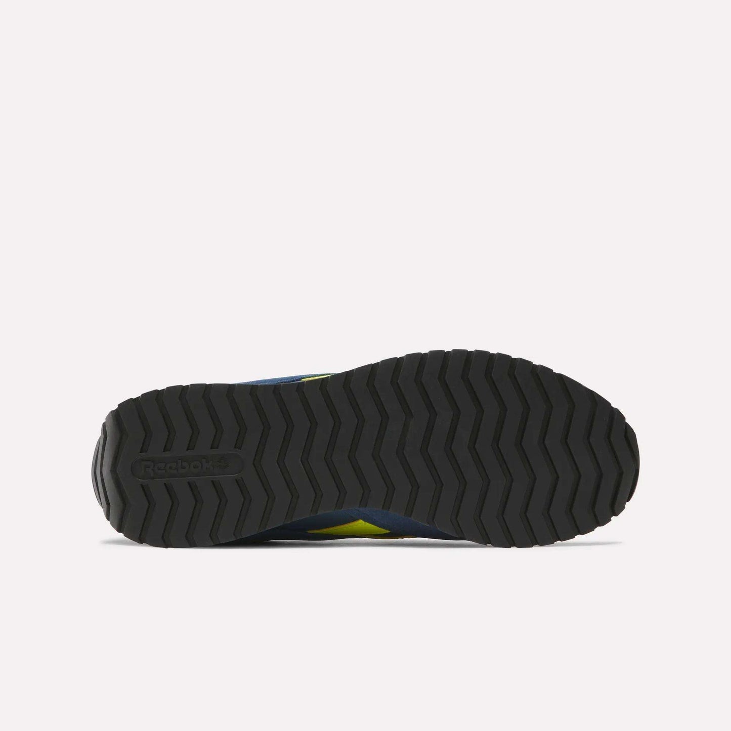 Bottom view of a black Reebok Classic AZ Shoes outsole, showing a zigzag tread inspired by '70s retro running shoes and the embossed Reebok logo on the heel, all set against a plain white background.