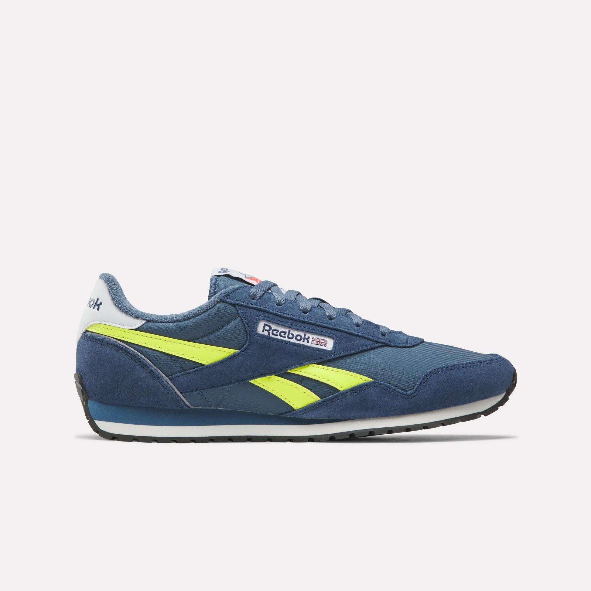 The Reebok Classic AZ Shoes in blue feature yellow accents and a white sole, displayed in side profile against a plain white background. '70s-inspired design details and the Reebok logo appear on the side and heel.