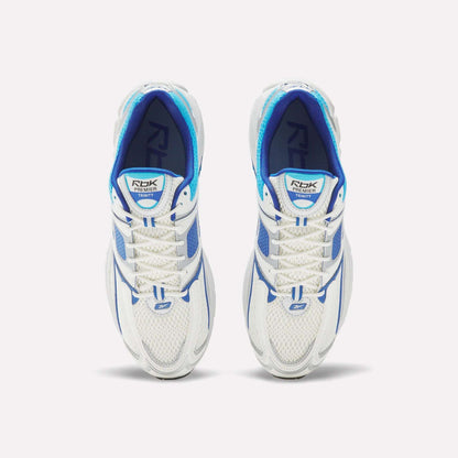 Top view of Reebok Premier Trinity Shoes—white mesh running shoes with blue accents and white laces—side by side on a plain white background, showcasing retro-inspired tech style.