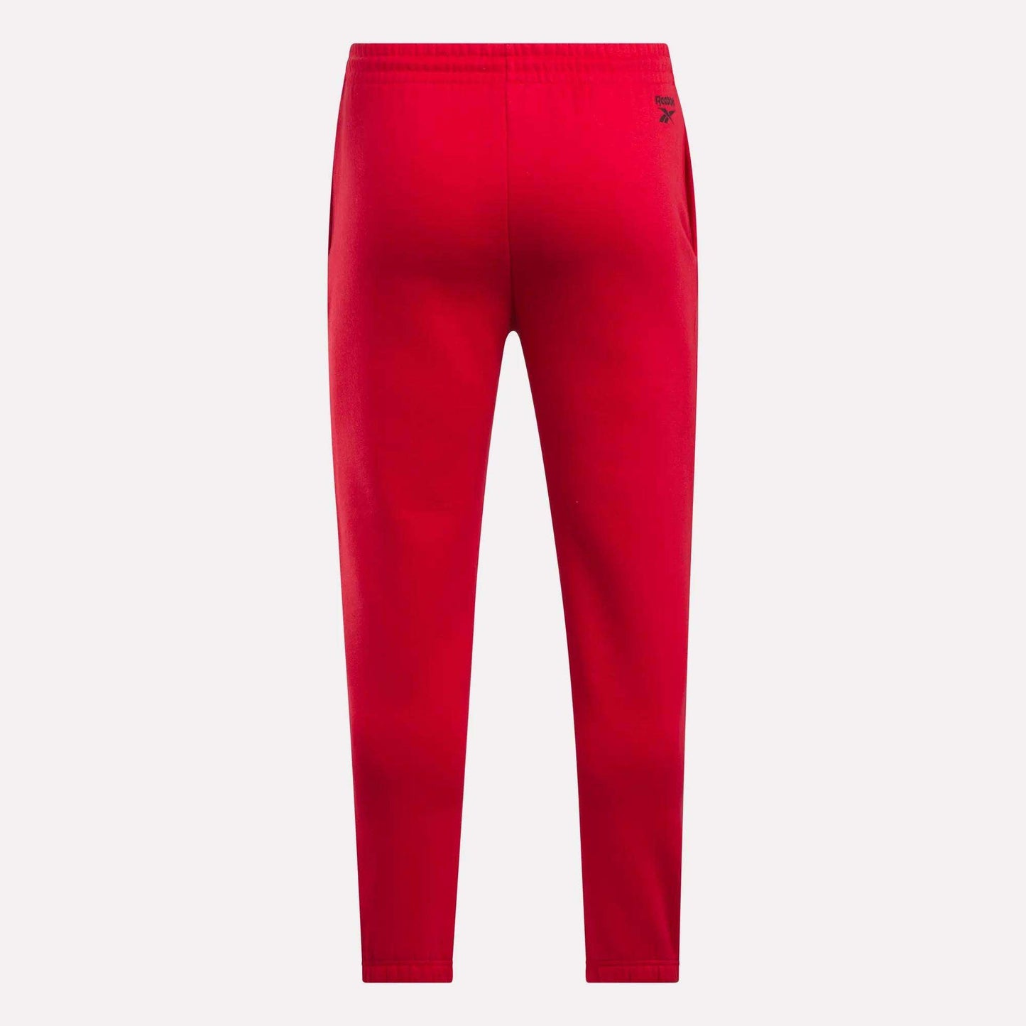 Reebok Men's Joggers in bright red fleece, featuring an elastic waistband, tapered legs, and a small black logo near the right hip, shown from the back on a plain white background.