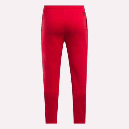 Reebok Men's Joggers in bright red fleece, featuring an elastic waistband, tapered legs, and a small black logo near the right hip, shown from the back on a plain white background.