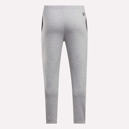 Back view of Reebok Men's Joggers in light gray with black side panels, elastic waistband, and a small logo on the left hip, shown against a plain white background.