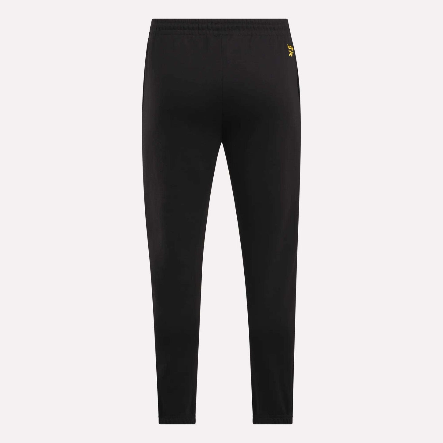 Reebok Men's Joggers shown from the back on a light background, featuring a slim fit, elastic waistband, and a small yellow logo near the waist for a stylish touch.