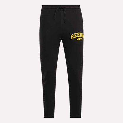 Black Reebok Men's Joggers with drawstring waist and yellow REEBOK logo on the left thigh, made from soft fleece material, shown against a white background.