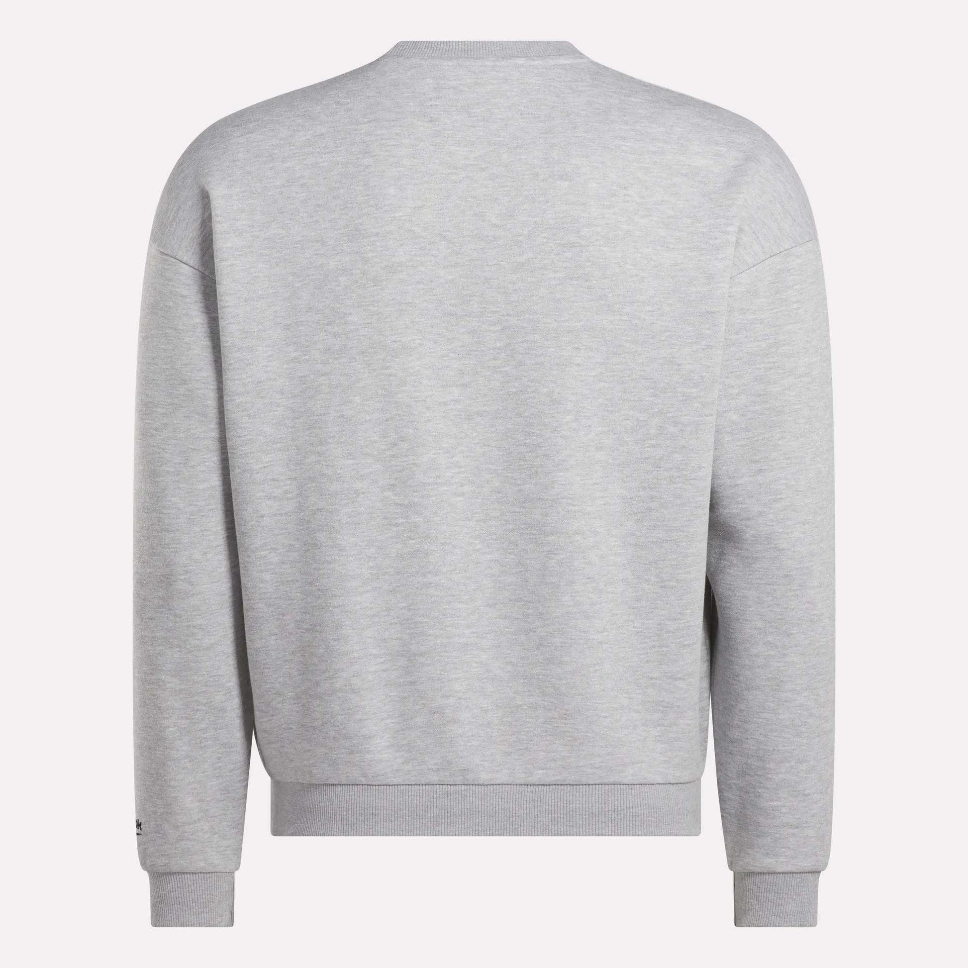 The Reebok Men's Cottle Sweatshirt is shown from the back in plain light gray, featuring a simple crewneck design with long sleeves and ribbed cuffs, hem, and collar.