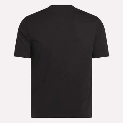 The Reebok Men's Small Logo Crewneck Short Sleeve T-Shirt is shown from the back in soft black cotton jersey. It features a simple crew neckline and minimal visible logos or designs, set against a light background.