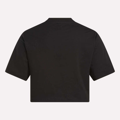 A Reebok Women's Two-Color Logo Crew Cropped Short Sleeve Tee, shown from the back, features a loose fit and short sleeves without visible designs—ideal for everyday comfort.