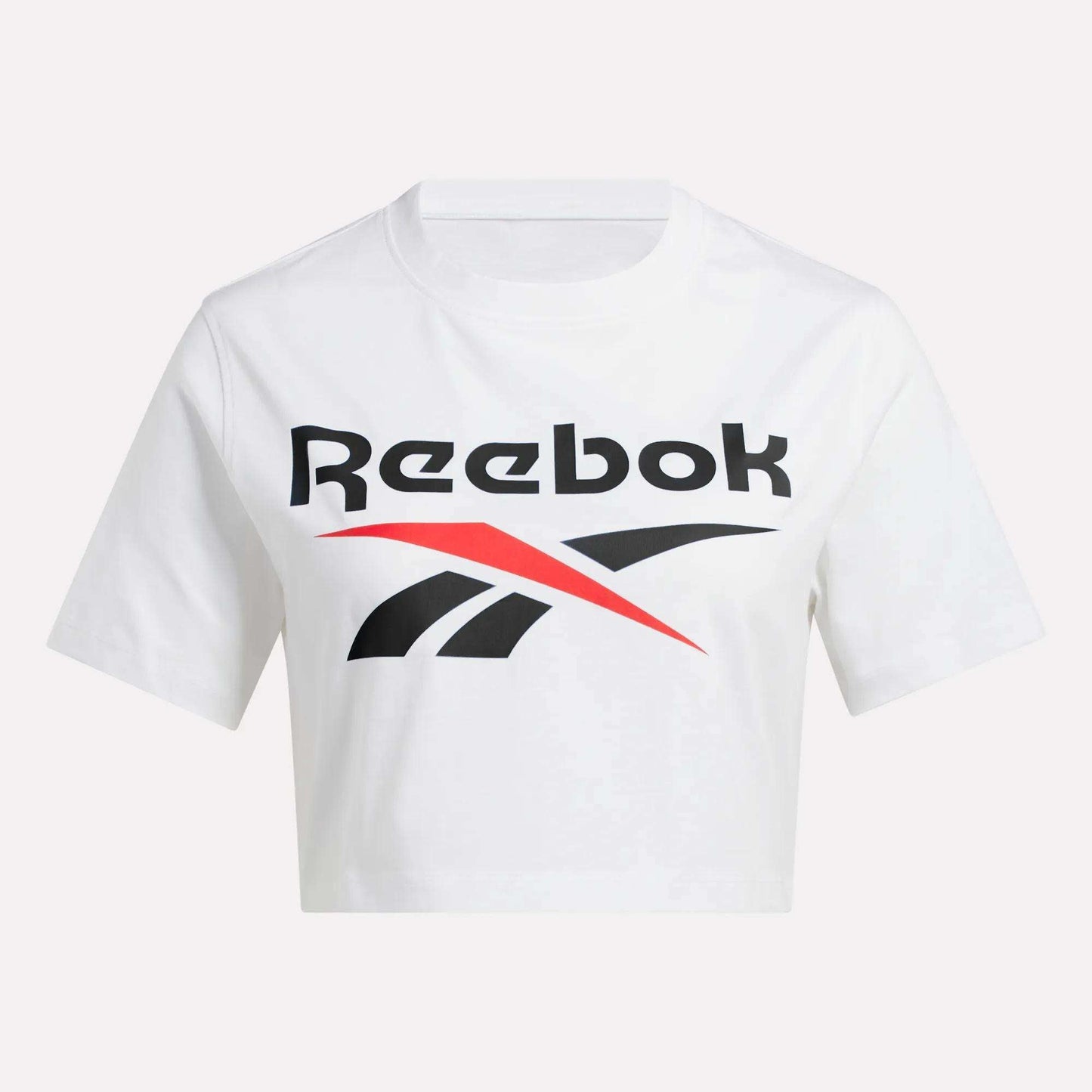 The Reebok Women's Two-Color Logo Crew Cropped Short Sleeve Tee is a white shirt with a large black logo and bold red and black swoosh across the chest.