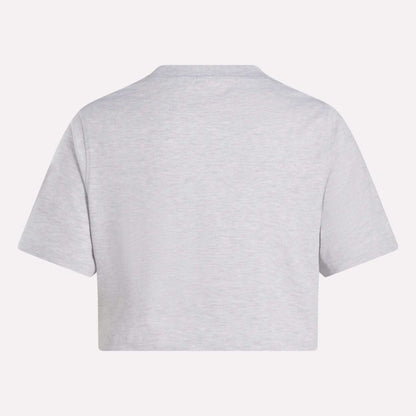 The Reebok Women's Two-Color Logo Crew Cropped Short Sleeve Tee is shown from the back in plain light gray against a white background.