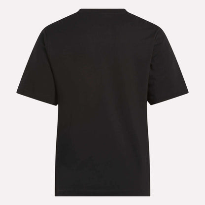 The Reebok Women's Big Logo Crewneck Short Sleeve Tee is shown from the back against a light background. This plain black cotton jersey t-shirt features no visible logos, patterns, or extra design elements.