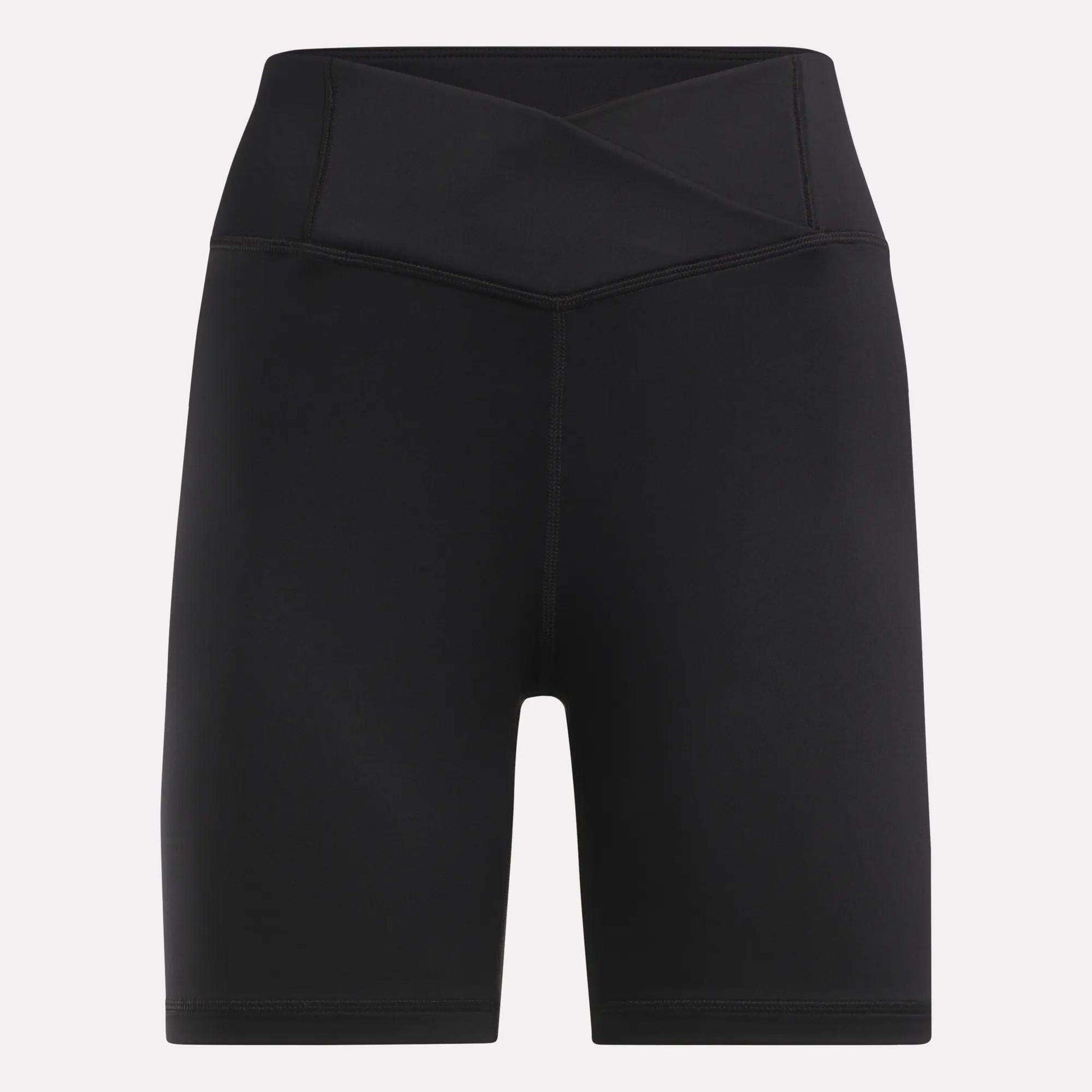 Reebok Women's Core High-Rise Cycle Shorts feature a black, sweat-wicking fabric, crossover waistband, and mid-thigh length. Displayed on a plain light background.