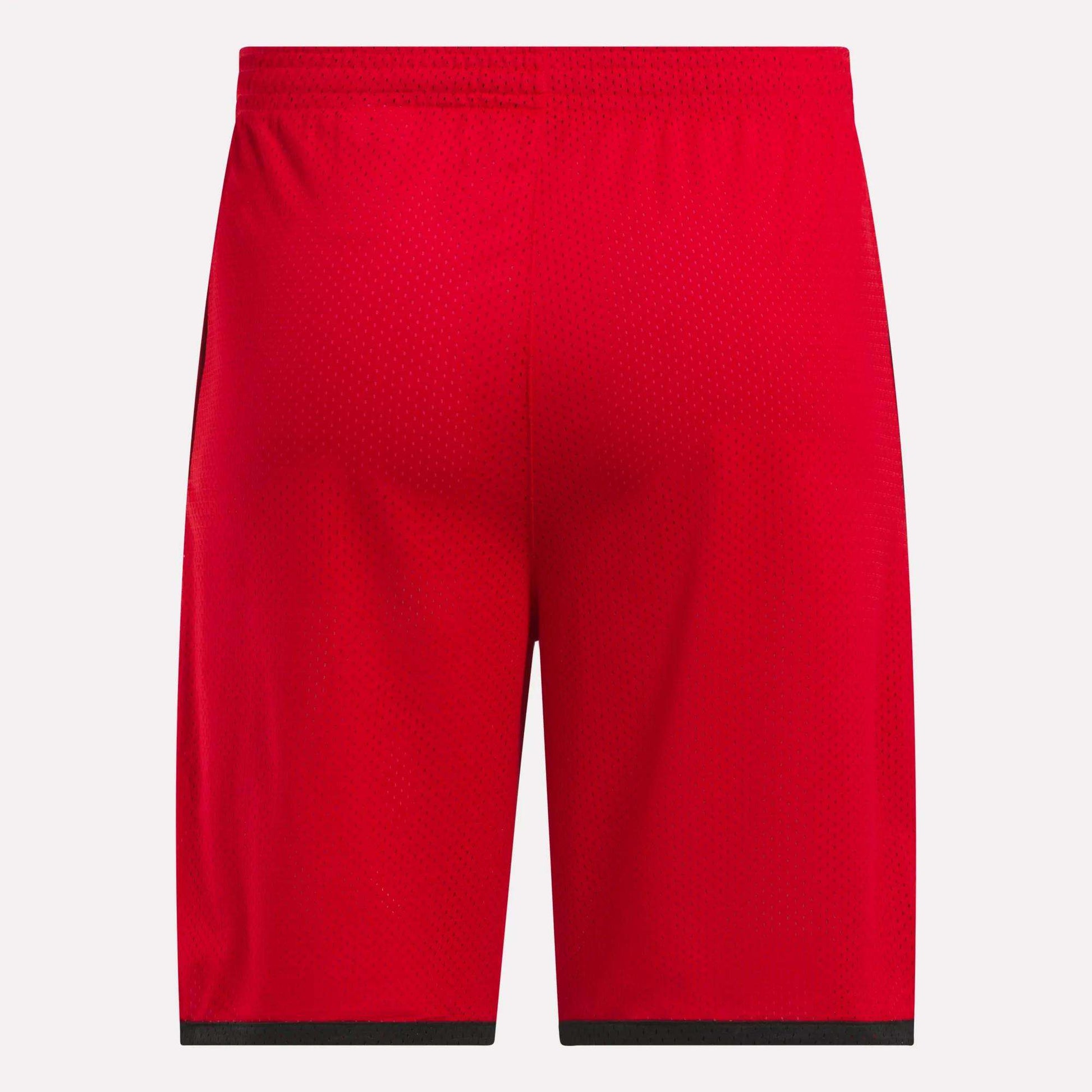 Back view of Reebok Men's Basketball Mesh Shorts in bright red, featuring an elastic waistband, black hem trim, and RBK-DRY technology for breathable comfort, shown against a white background.