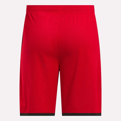 Back view of Reebok Men's Basketball Mesh Shorts in bright red, featuring an elastic waistband, black hem trim, and RBK-DRY technology for breathable comfort, shown against a white background.