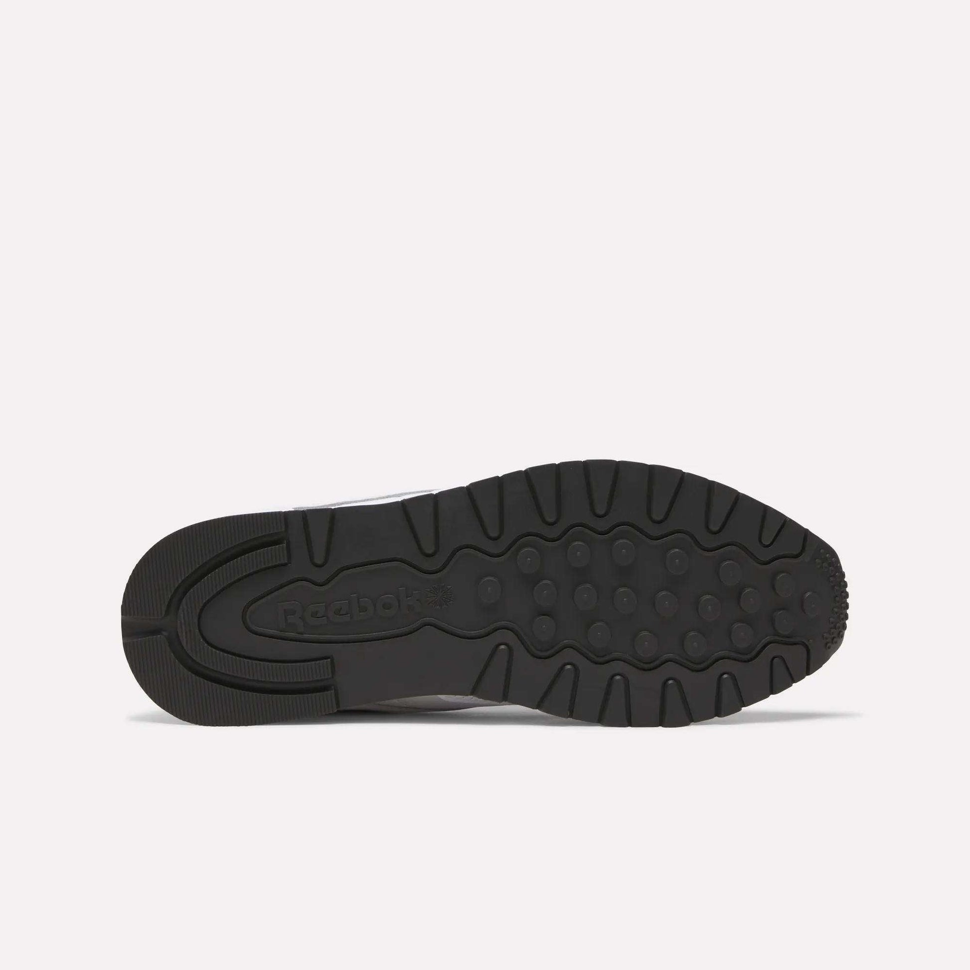 The black rubber sole of Reebok Classic Leather Shoes features a retro running tread with circular grips and the Reebok logo embossed at the midfoot.