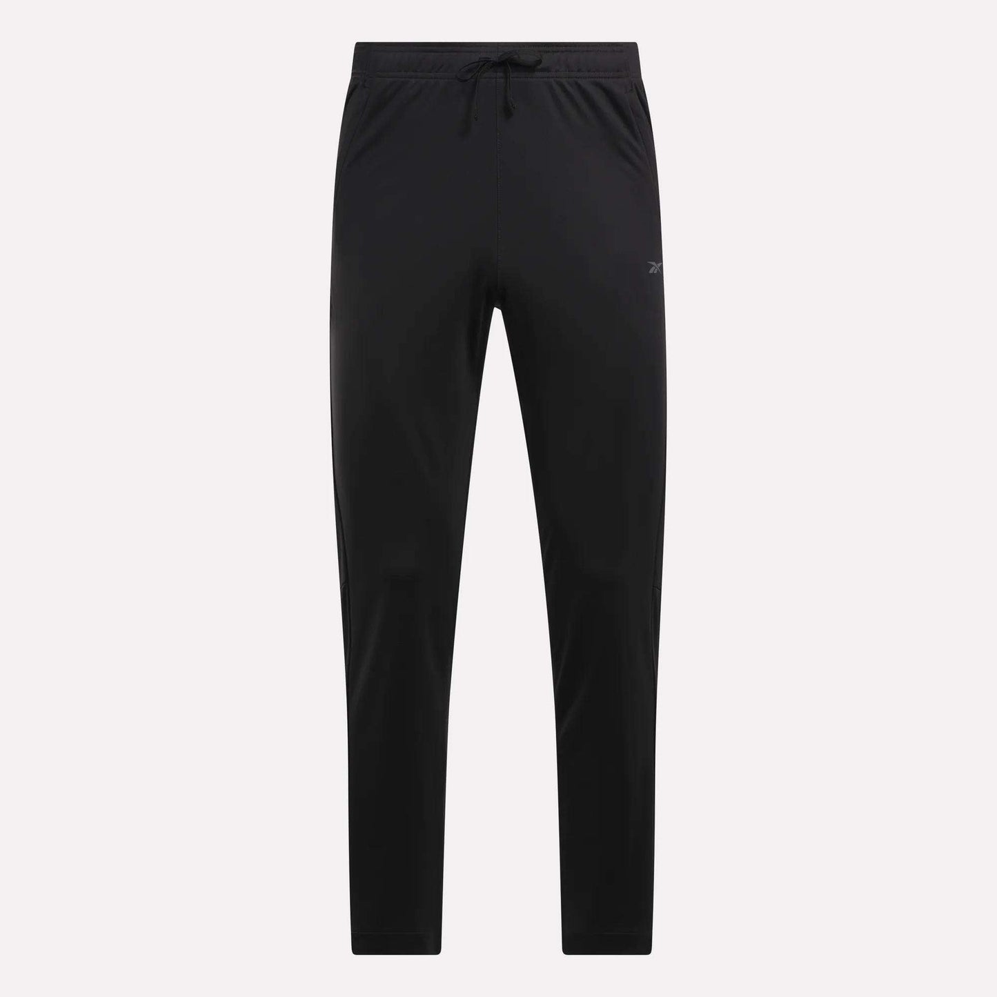 Reebok Men's Train Knit Pants shown in black with a slim fit, elastic waistband, and drawstring. These minimalistic pants are ideal for workouts or casual wear, displayed against a light plain background.
