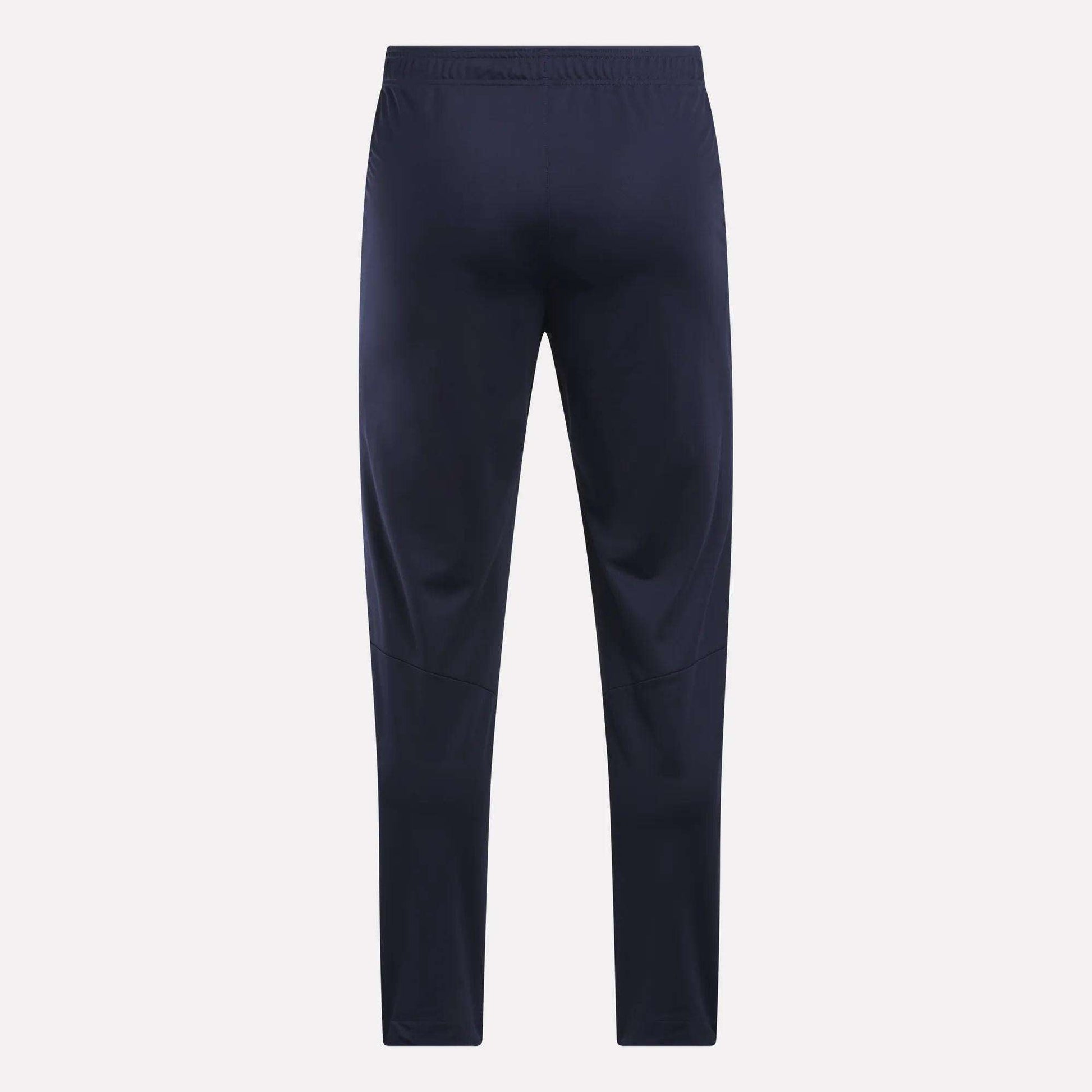 Men's Train Knit Pants by Reebok in navy blue, featuring an elastic waistband, displayed flat and facing forward against a plain light background.