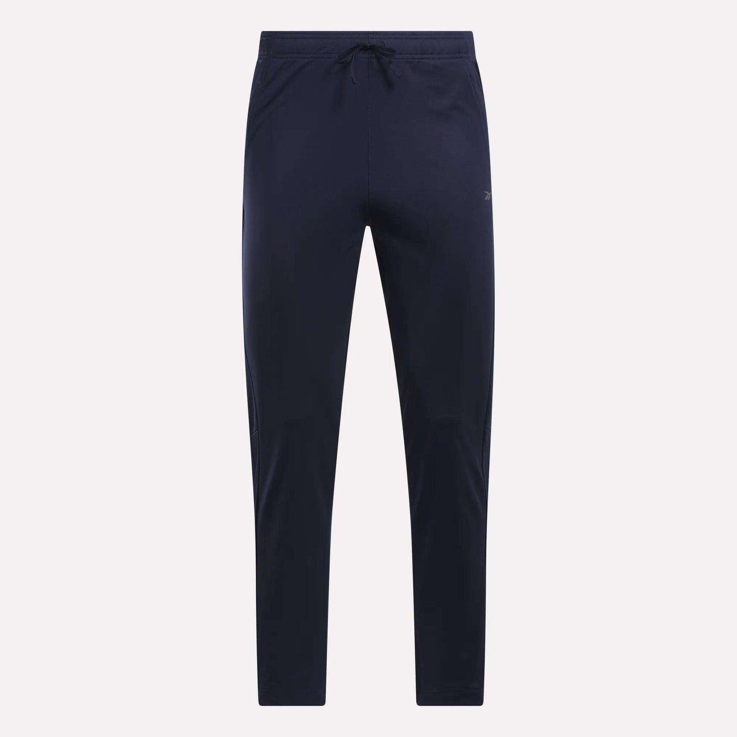 Reebok Men's Train Knit Pants in navy blue, featuring a slim fit jogger style with an elastic waistband and drawstring. Displayed against a plain light background, these gym pants have no visible logos or patterns.