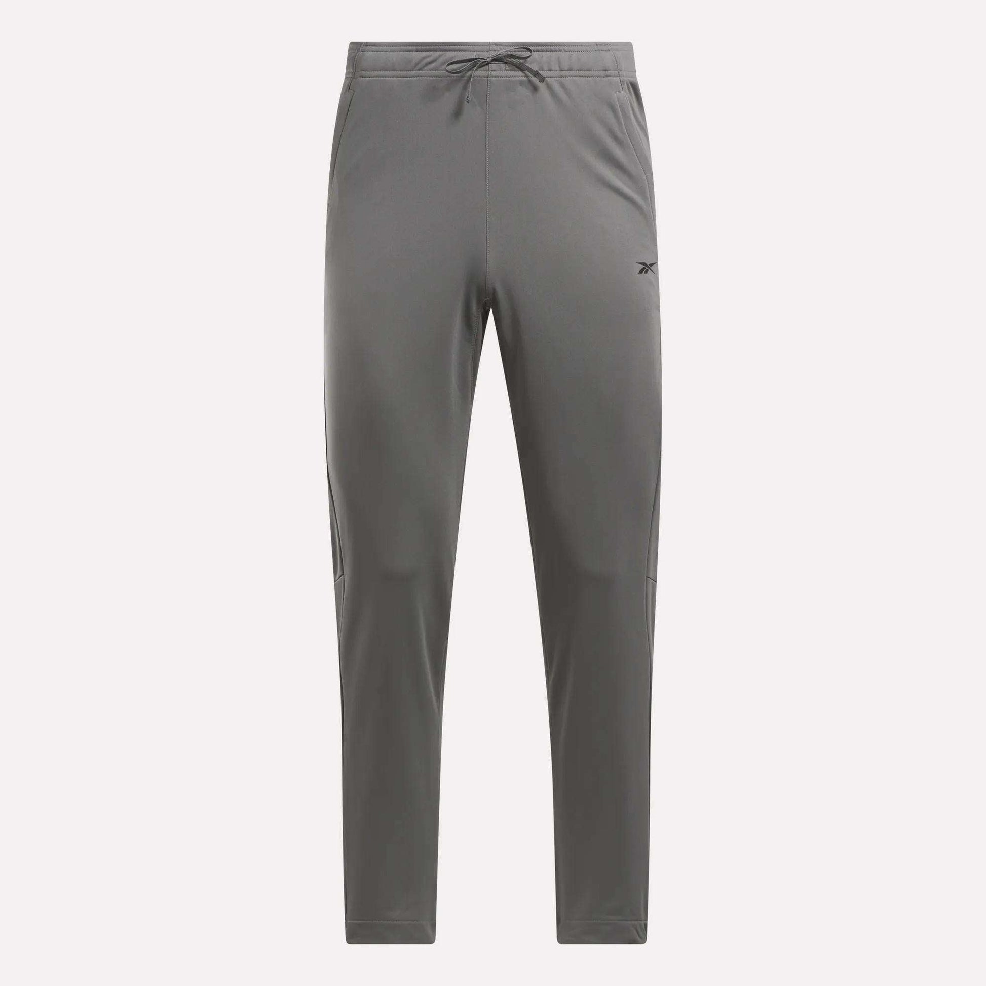 Men's Train Knit Pants by Reebok, gray with a drawstring waistband, tapered legs, and a small logo on the left thigh, shown against a plain white background.