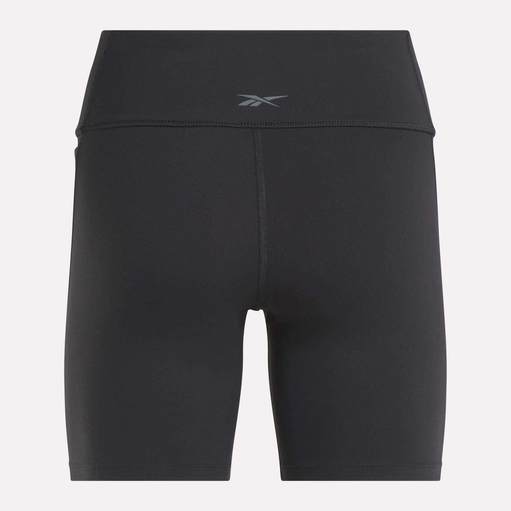Back view of Reebok Women's Lux High-Rise Bike Shorts in black with a small waistband logo. Crafted from stretchy RBK-DRY fabric and designed with flatlock stitching for comfort and performance.