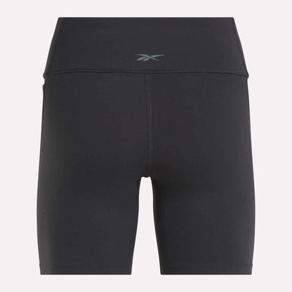 Back view of Reebok Women's Lux High-Rise Bike Shorts in black with a small waistband logo. Crafted from stretchy RBK-DRY fabric and designed with flatlock stitching for comfort and performance.
