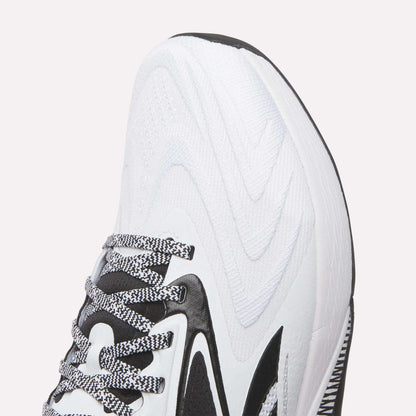 Close-up of the front and side of Reebok Nano X5 Edge Training Shoes, showing black accents, a wavy textured pattern, black-and-white laces, and part of the sole designed for optimal performance.