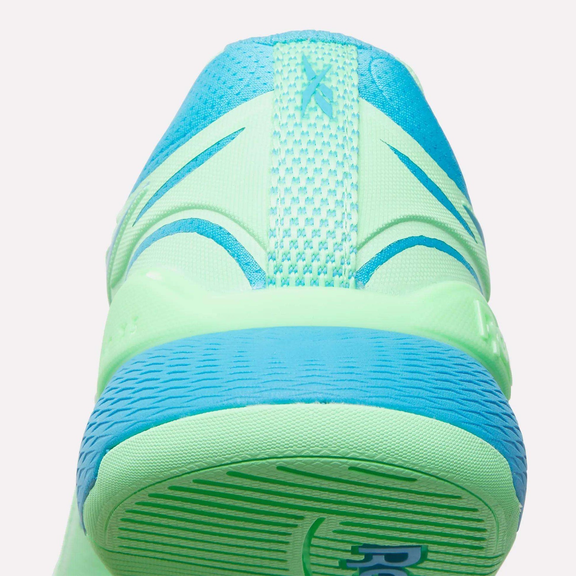 Close-up rear view of neon green and blue Reebok Women's Nano X5 Edge Training Shoes, featuring a textured heel, mesh upper, and visible stitching—perfect for your next HIIT class.