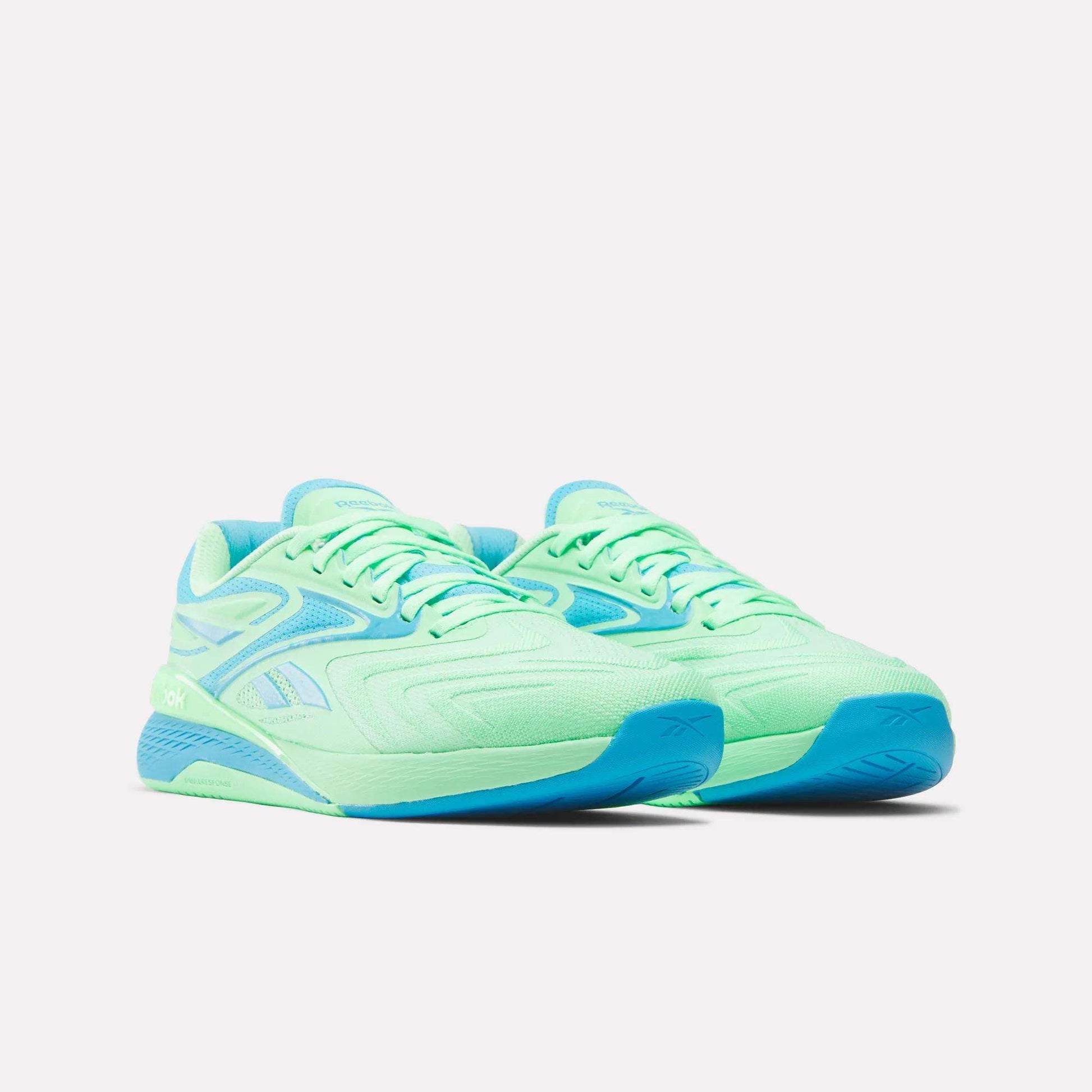 Reebok Women's Nano X5 Edge Training Shoes in light green with blue accents and blue soles, ideal for HIIT classes, shown on a plain white background.