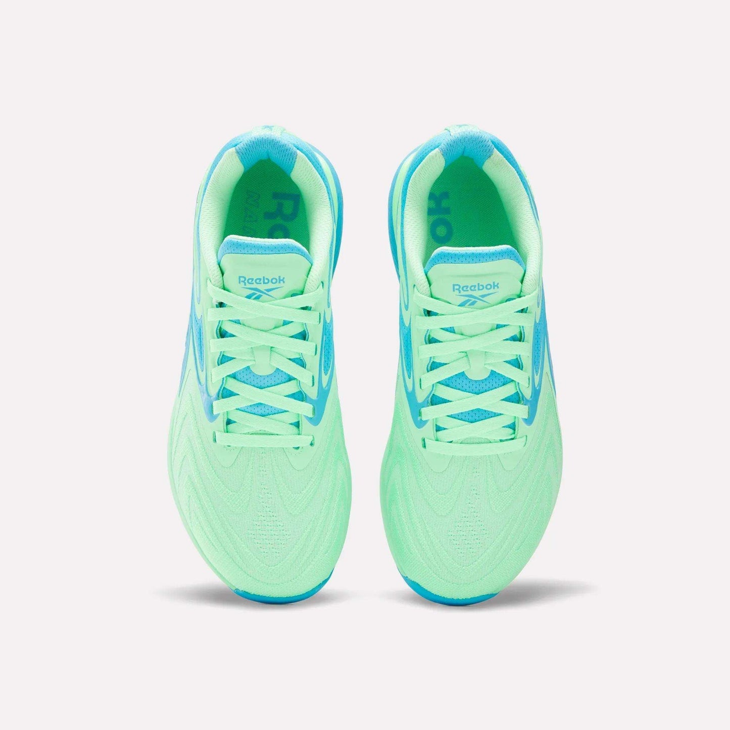 Top view of Women's Nano X5 Edge Training Shoes by Reebok in neon green with light blue accents, laces, and lining, shown side by side on a white background—perfect for your next HIIT class.